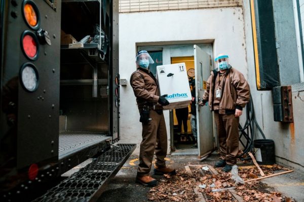 A UPS employee holds a box containing some of the first Pfizer-BioNTech Covid-19 vaccines before delivering it into the Donald Berman Maimonides Geriatric Centre in Montreal, Quebec on December 14, 2020.